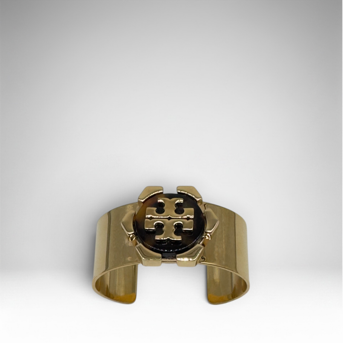 Tory Burch gold-tone open cuff bracelet with brown logo medallion and presentation box
