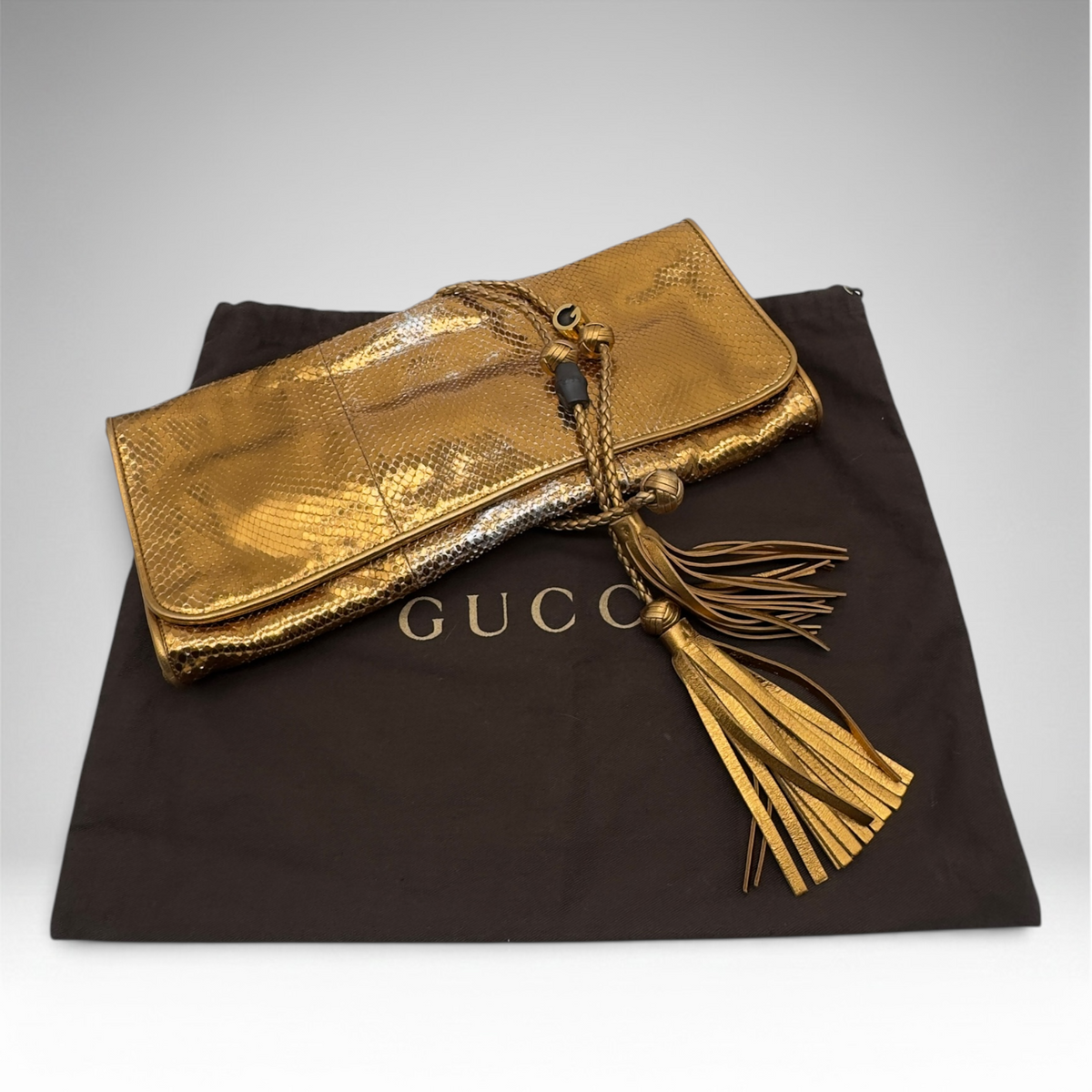 Gucci snakeskin gold clutch