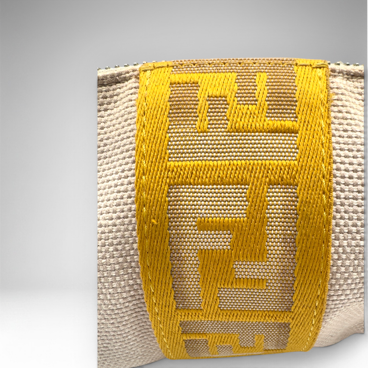 Fendi beige woven canvas pochette with mustard-yellow FF logo webbing and gold-tone zip closure, view 2