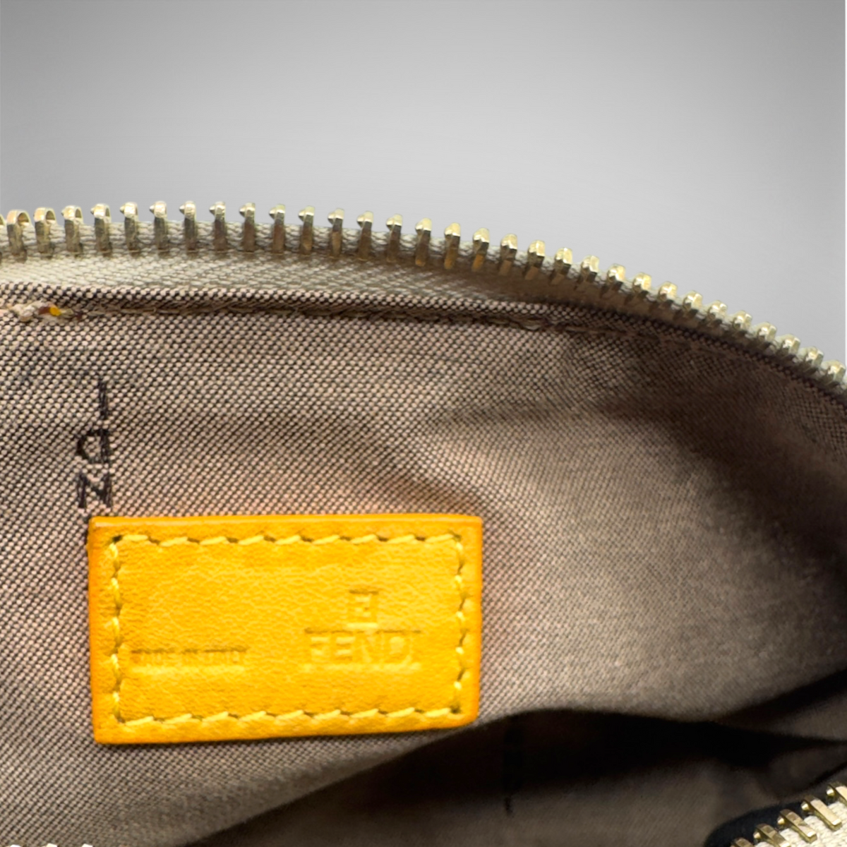 Fendi beige woven canvas pochette with mustard-yellow FF logo webbing and gold-tone zip closure, view 4